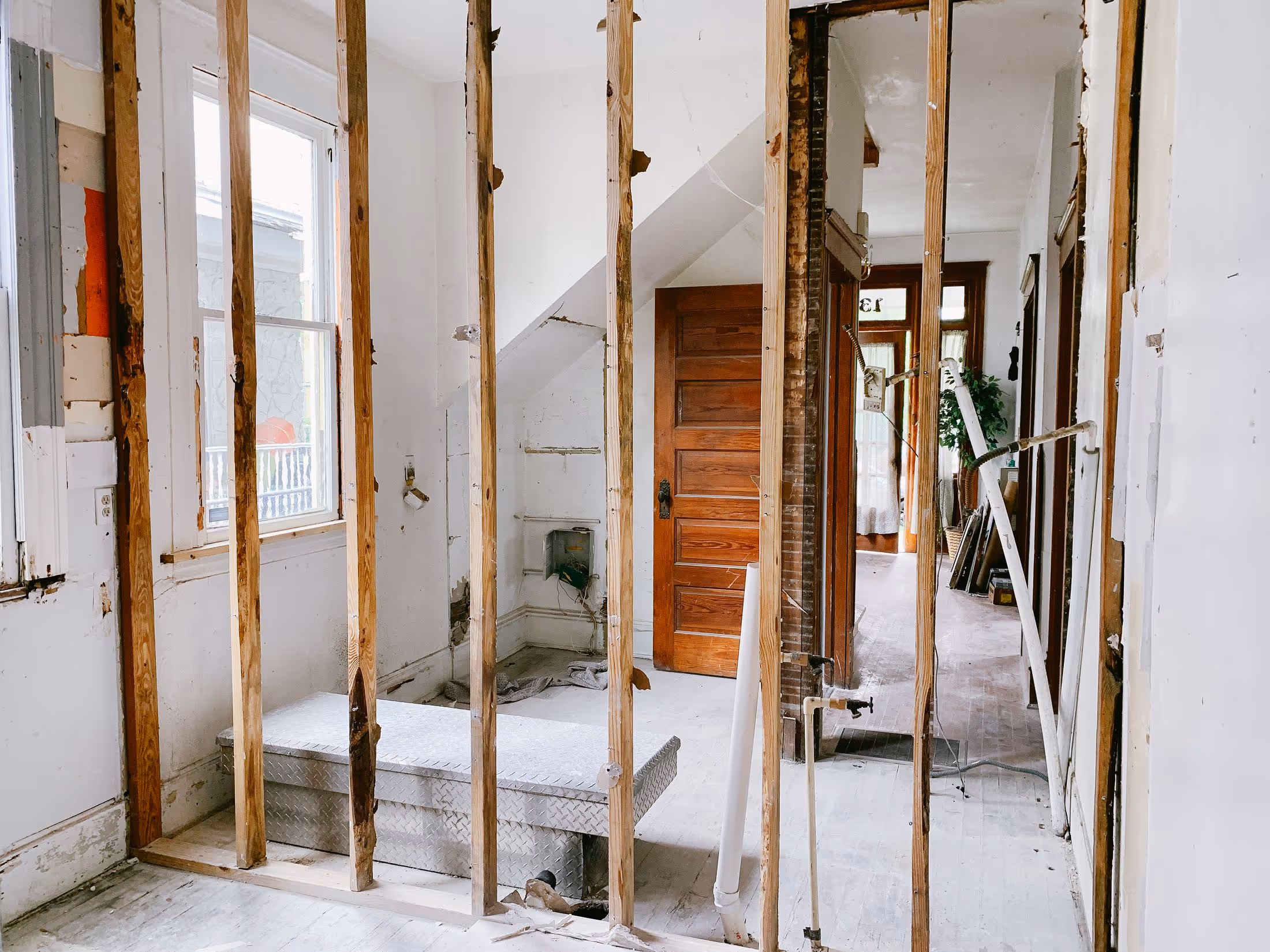 Interior mid-renovation with exposed wall studs